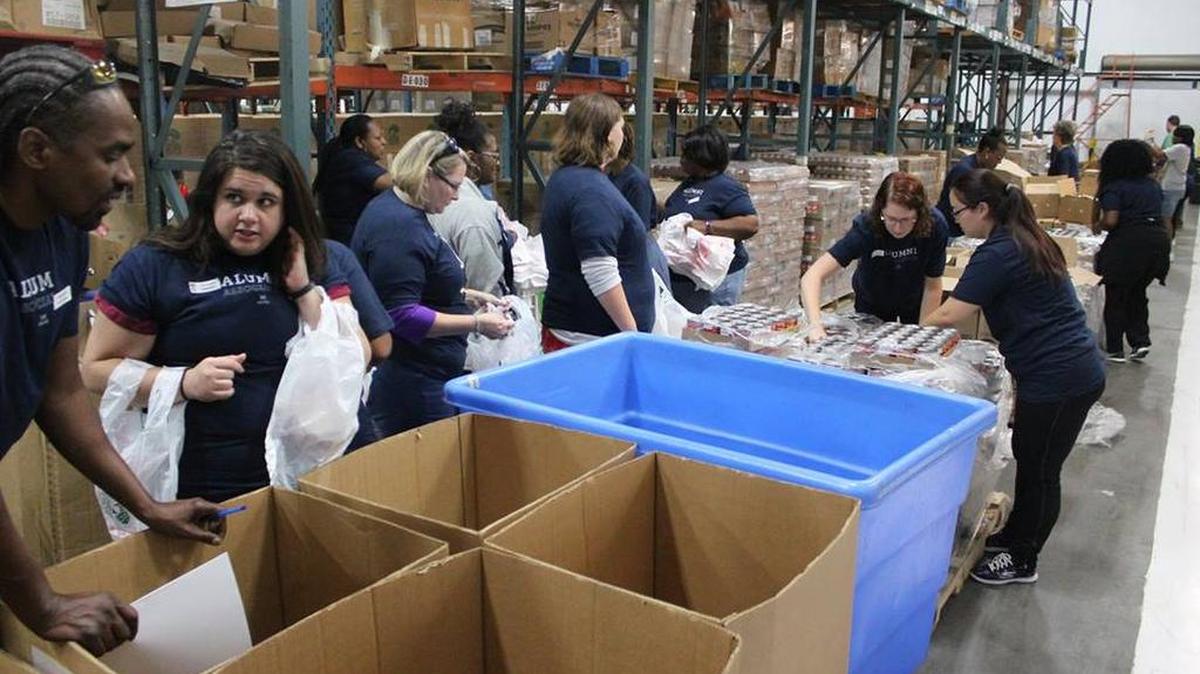 Volunteers help package food at Harvest Hope Food Bank’s Shop Road facility on the Saturday before Hurricane Irma made U.S. landfall.