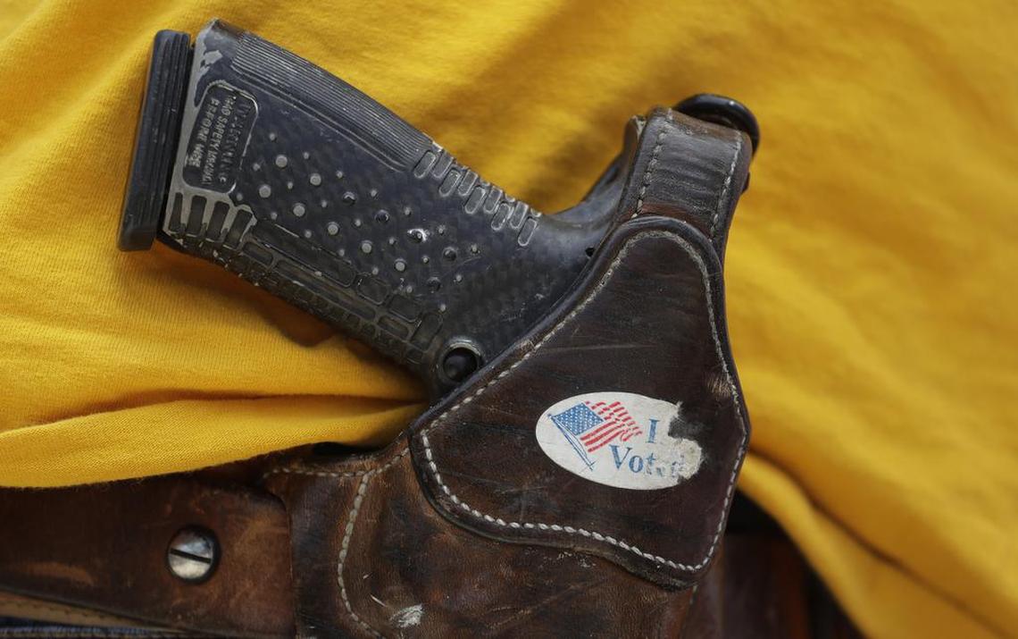 In this April 14, 2018 file photo, a man wears an unloaded pistol during a pro gun-rights rally in Austin, Texas.
