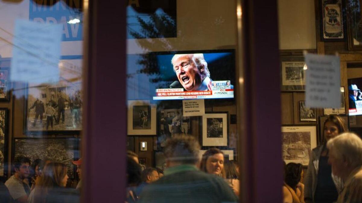 Republican presidential candidate Donald Trump is displayed on a television at Manuel's Tavern as patrons wait to watch the first presidential debate in September.