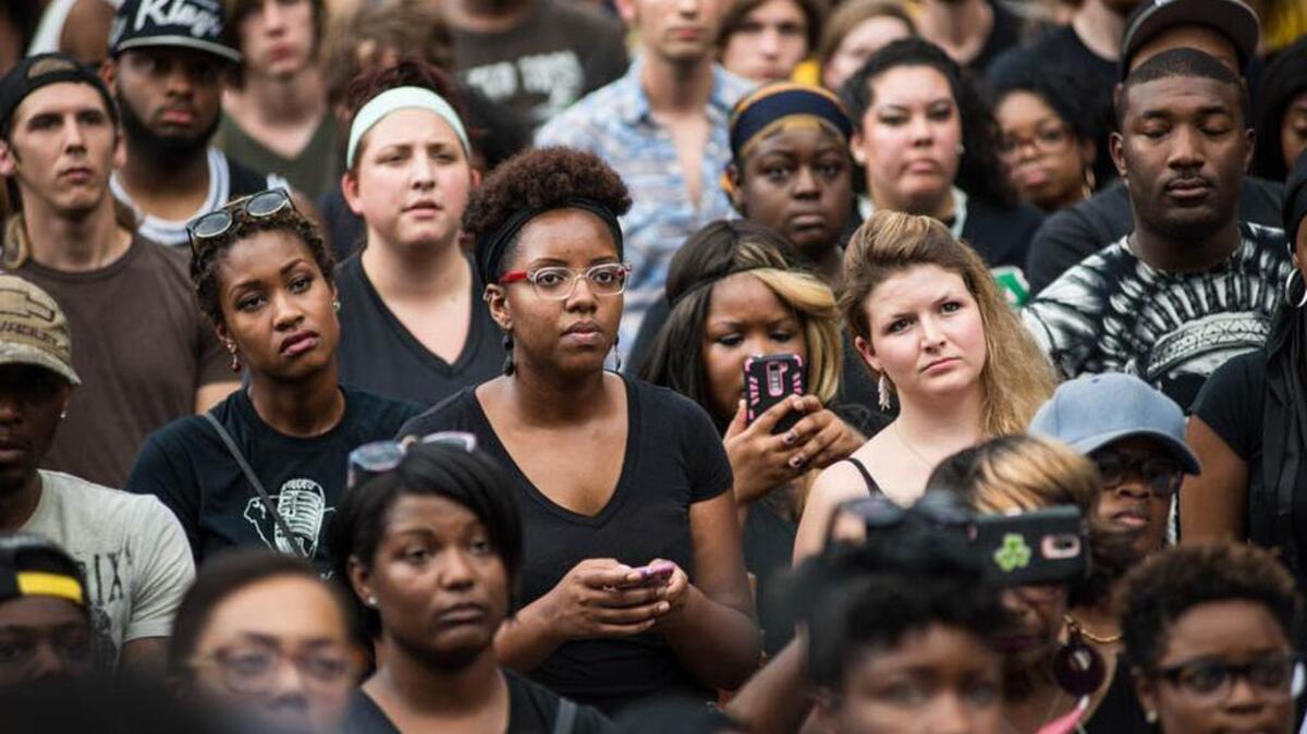 Protesters listen to a speaker at Sunday’s United We Stand march in Columbia.