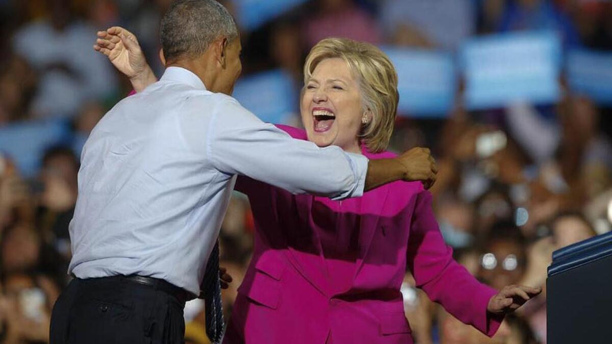 President Barack Obama and Democratic presidential candidate Hillary Clinton embrace during a campaign rally in July.