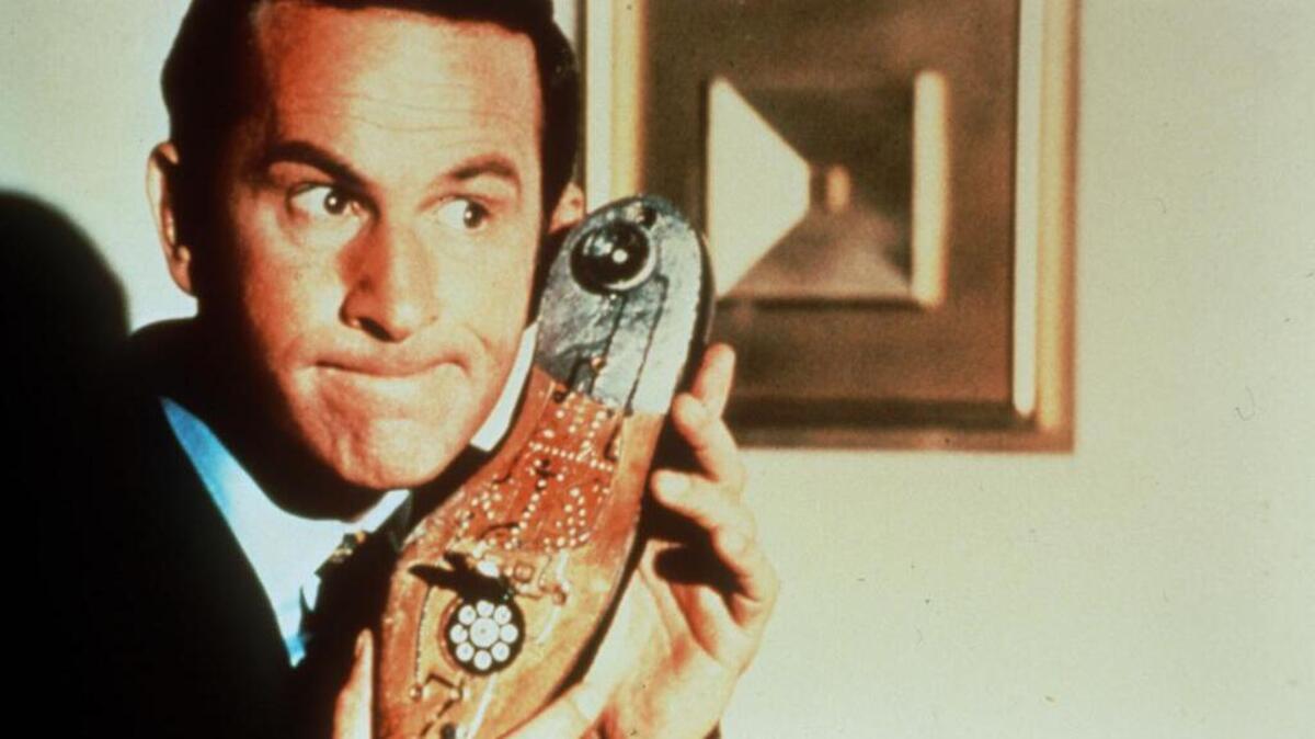 Agent Maxwell Smart speaks into his shoe telephone in the classic spy series “Get Smart.”
