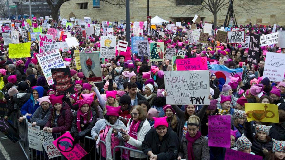 Women with bright pink hats and signs gathered Saturday for the Women’s March on Washington.