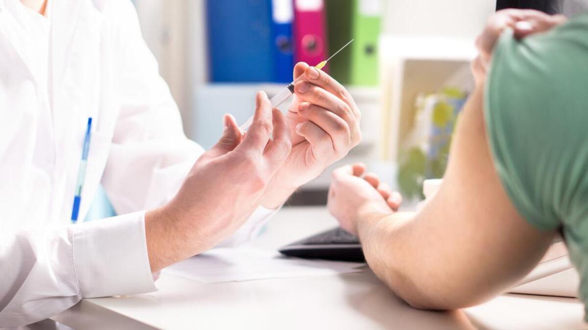 Patient gets ready to receive a flu shot. (Dreamstime/TNS)