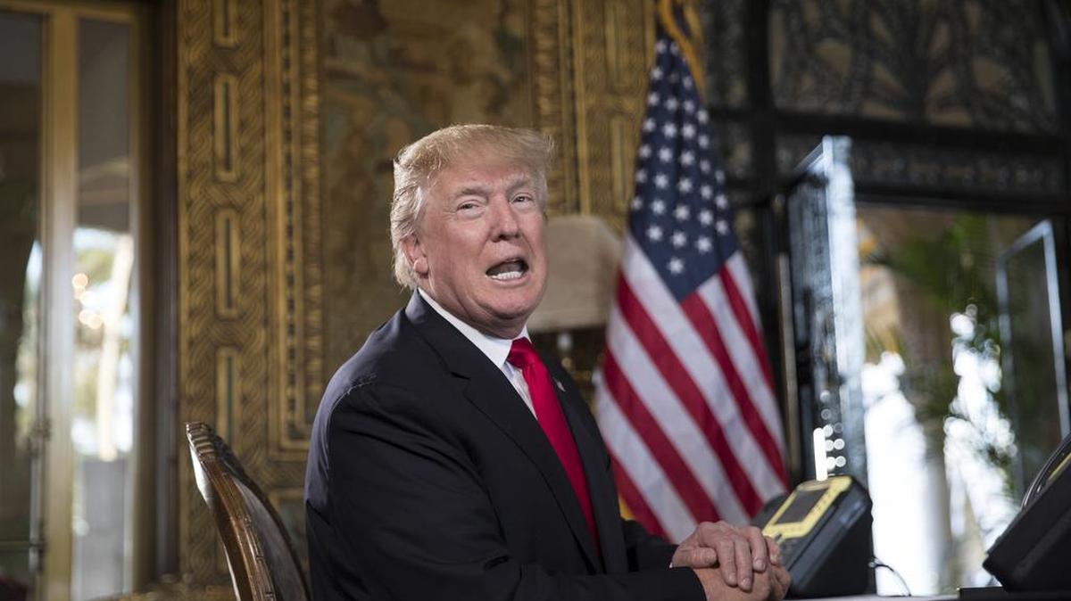 President Donald Trump turns to talk to the gathered media during a Christmas Eve video teleconference with members of the mIlitary.