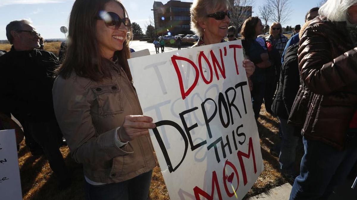 Supporters hold up a placard during a rally in Colorado Wednesday for a Mexican woman seeking to avoid deportation from the United States.