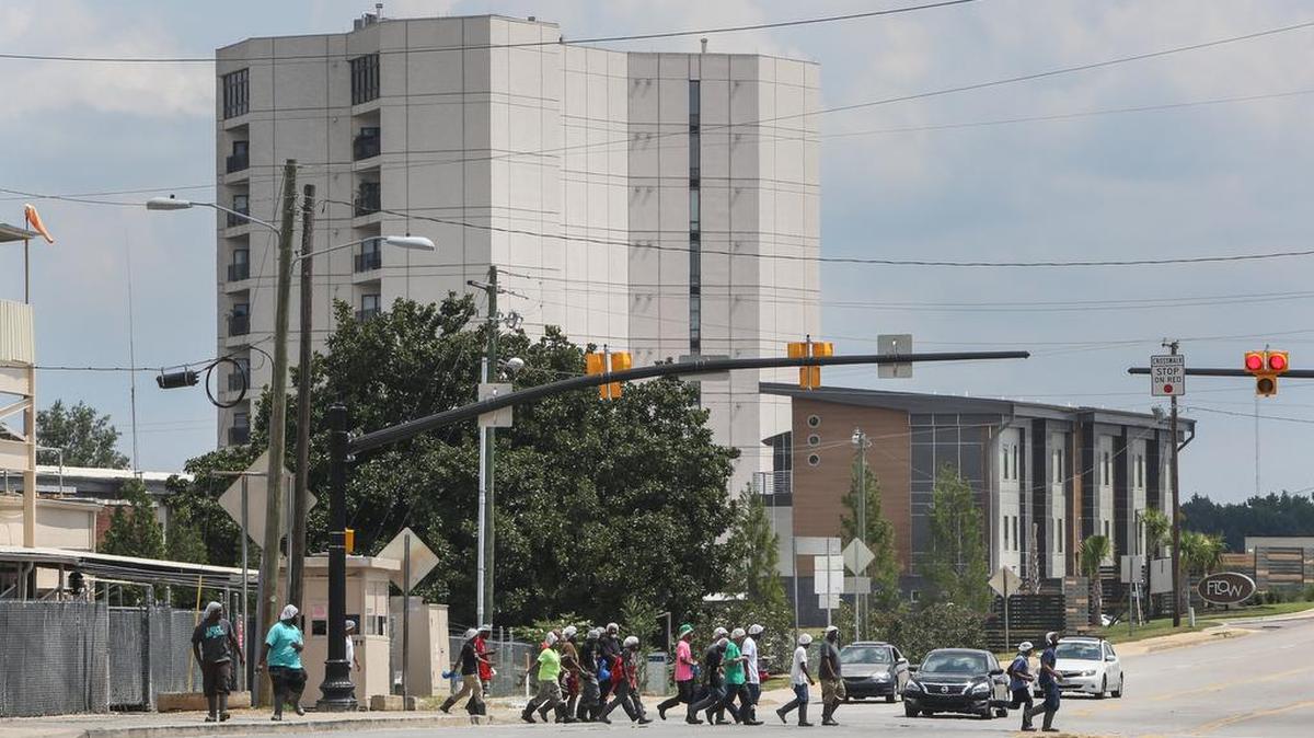 Workers at House of Raeford Chicken processing plant cross Sunset Boulevard in West Columbia during their lunch break.