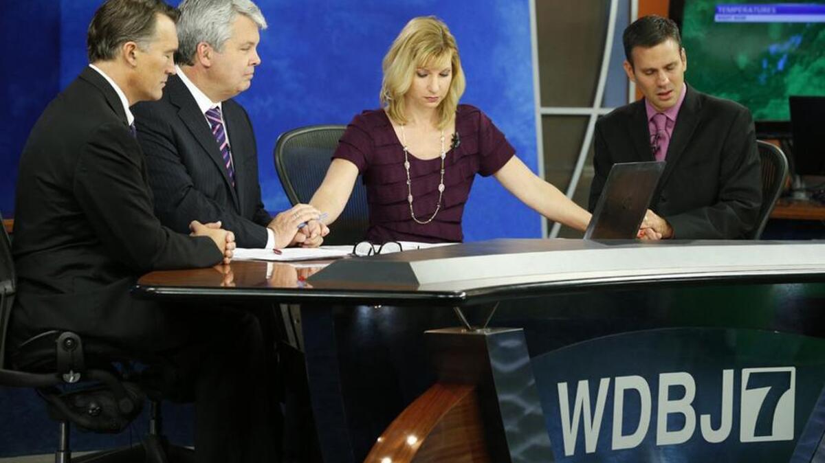 
WDBJ-TV7 news morning anchor Kimberly McBroom and meteorologist Leo Hirsbrunner and visiting anchor Steve Grant and Dr. Thomas Milam observe a moment of silence 24 hours after reporter Alison Parker and cameraman Adam Ward were killed during a live broadcast.
