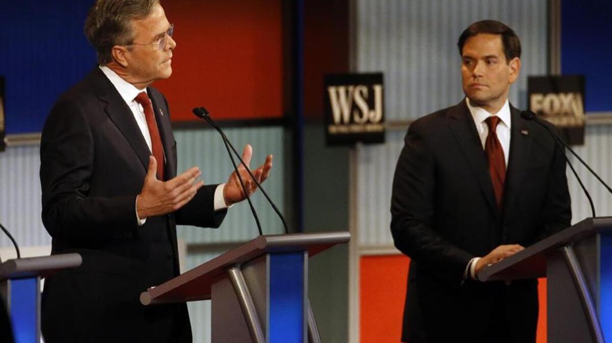 Jeb Bush speaks as Marco Rubio listens during a Republican presidential debate in November.