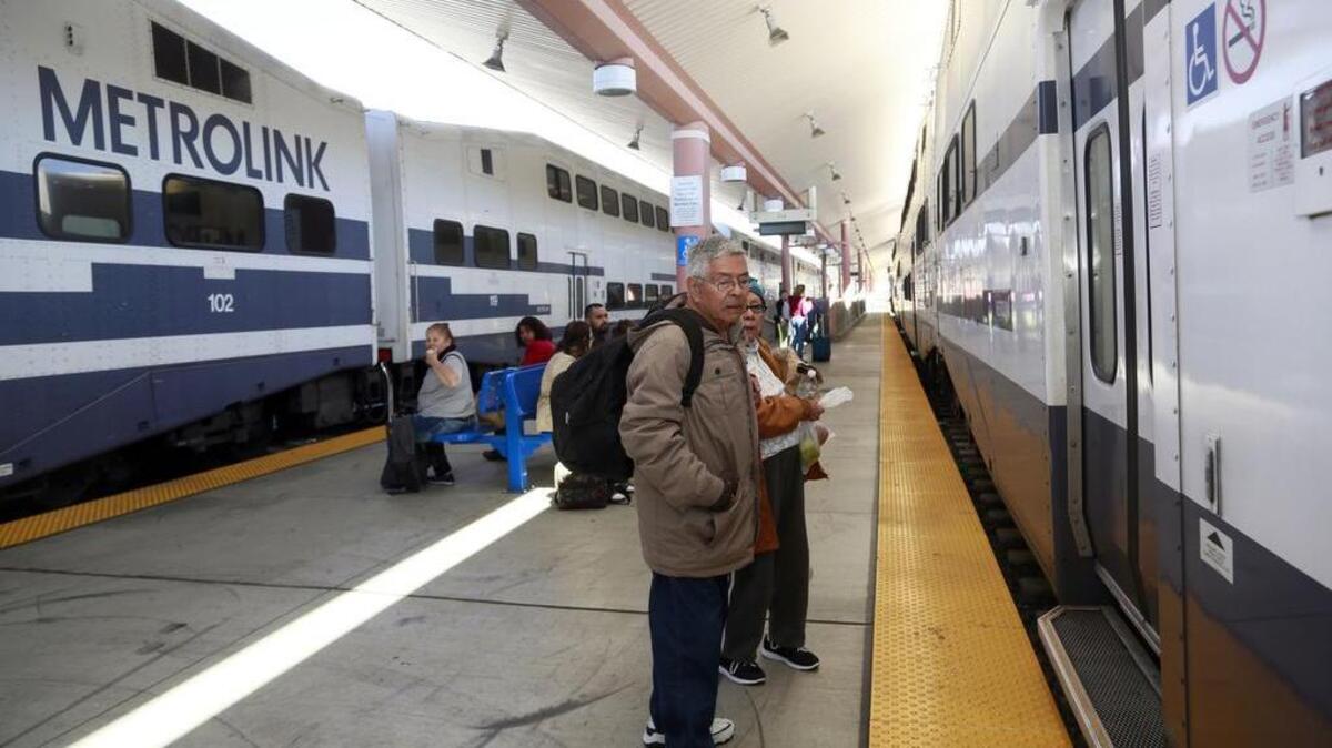 Passengers wait to board a Metrolink commuter train in Los Angeles.