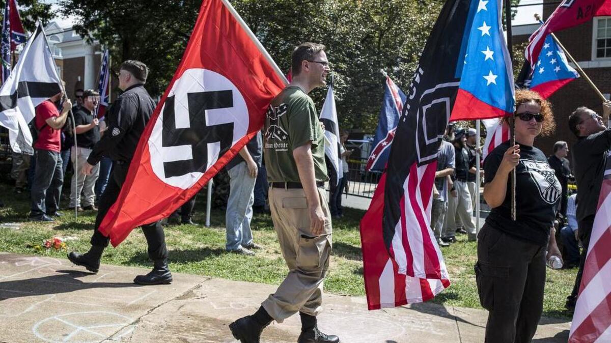 A white nationalist carries a Nazi flag during a protest Saturday in Charlottesville, Va.