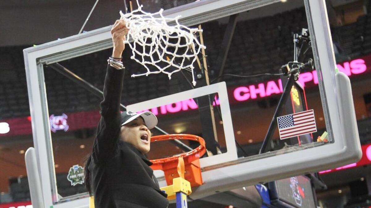 University of South Carolina women’s basketball Coach Dawn Staley hoists the net after winning the NCAA National Championship in April.