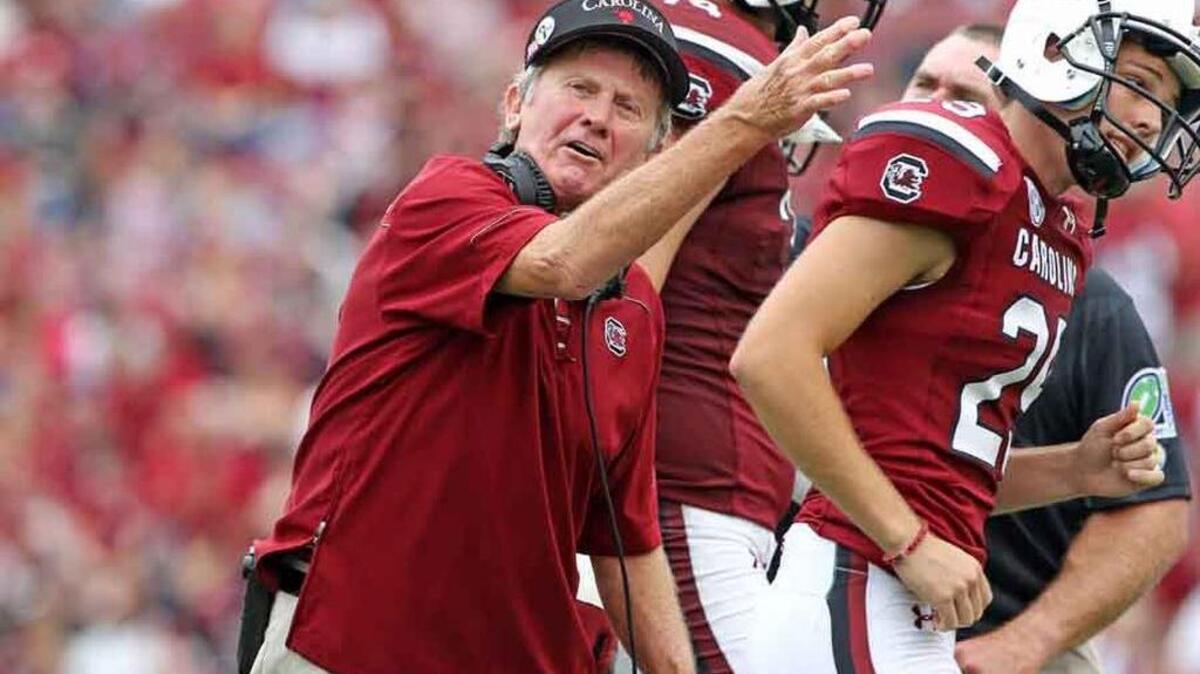 
USC head football coach Steve Spurrier congratulates place kicker Elliott Fry after his field goal in the fourth quarter against UCF on Sept. 26.
