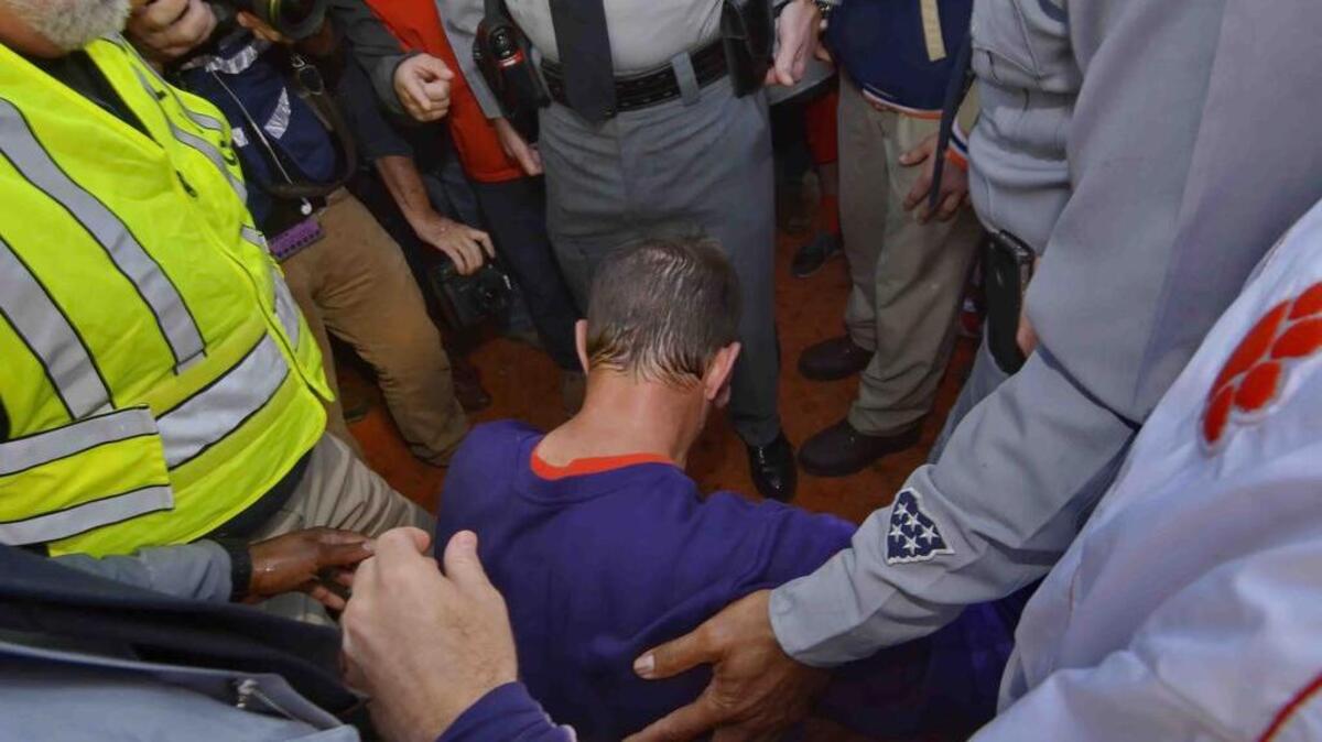 
Clemson head football coach Dabo Swinney kneels and prays after a game.
