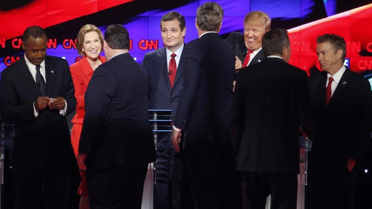 Republican presidential candidates Ben Carson, Carly Fiorina, Chris Christie, Ted Cruz, Jeb Bush, Donald Trump, John Kasich and Rand Paul talk following a debate in December 2015.