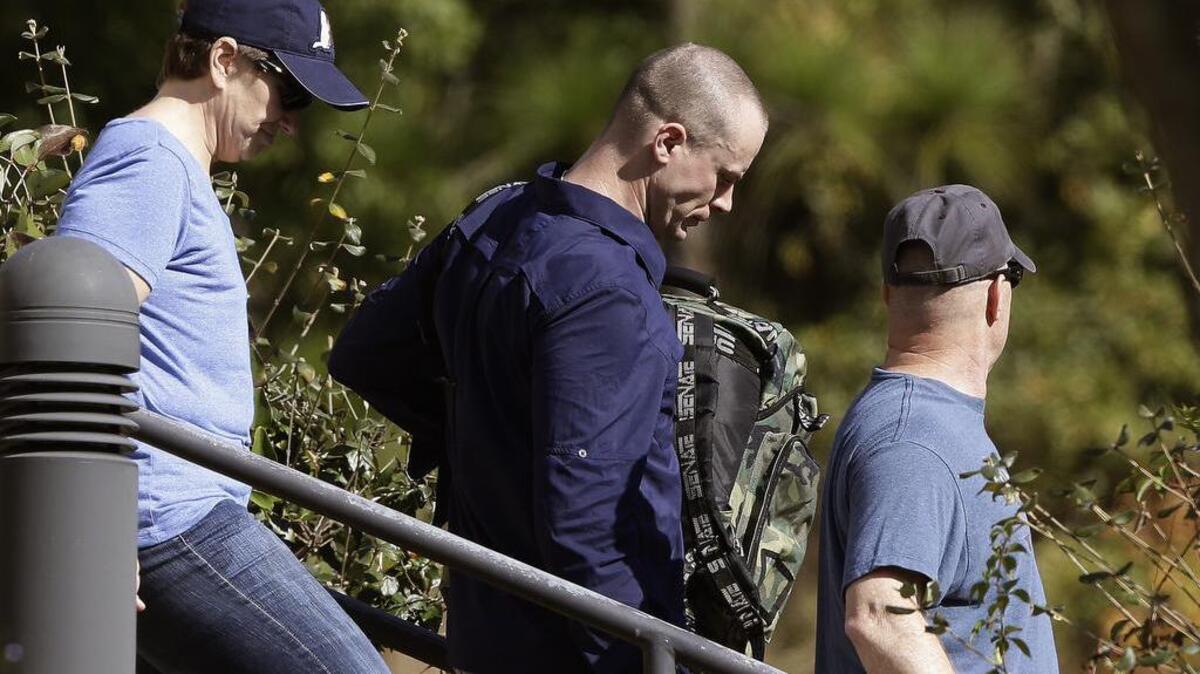 Bowe Bergdahl, center, leaves the Fort Bragg courtroom facility following sentencing at Fort Bragg, N.C. The former sergeant was spared prison time and received a dishonorable discharge from the Army. Bergdahl, who walked off his base in Afghanistan in 2009 and was held by the Taliban for five years, pleaded guilty to desertion and misbehavior before the enemy.