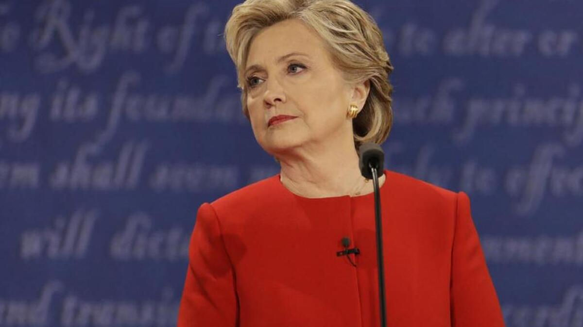 Democratic presidential nominee Hillary Clinton listens to Republican presidential nominee Donald Trump during Monday’s presidential debate.