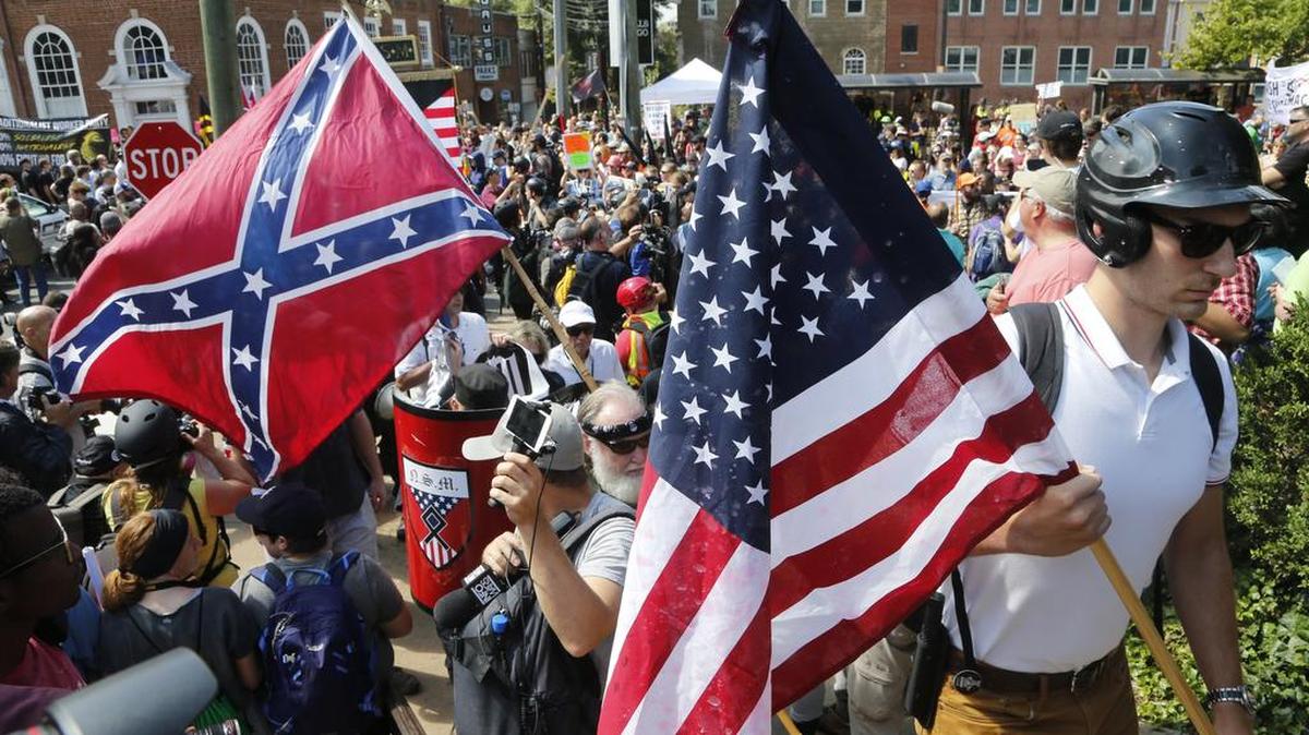 White nationalist demonstrators walk into Lee park surrounded by counter demonstrators in Charlottesville, Va., last month.