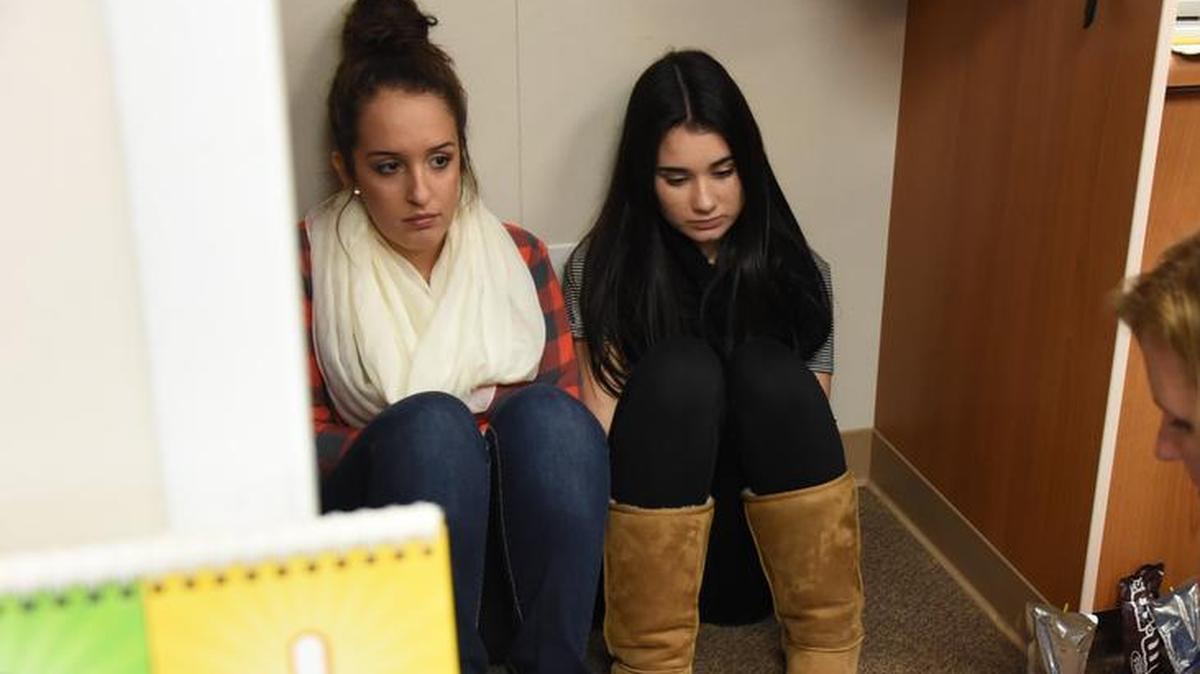 High school students take cover during an active shooter training session.