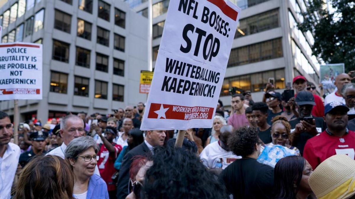 People gather in support of unsigned NFL quarterback Colin Kaepernick on Wednesday, Aug. 23, 2017, outside NFL headquarters in New York. (AP Photo/Craig Ruttle)
