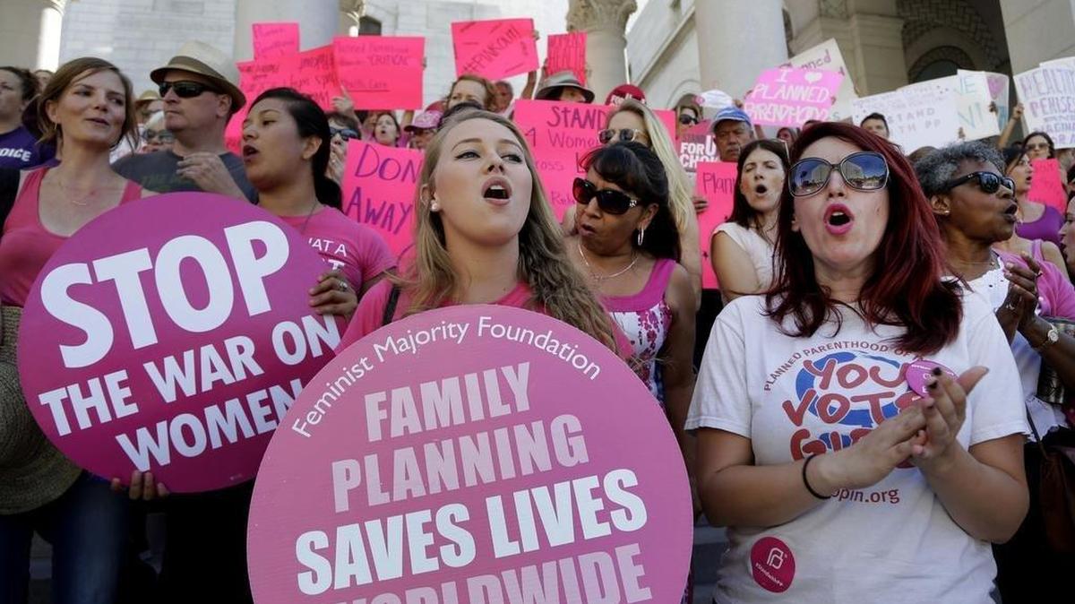 Planned Parenthood supporters rally for women’s access to reproductive health care on ``National Pink Out Day’’ at Los Angeles City Hall, Tuesday, Sept. 29, 2015. (AP Photo/Nick Ut)