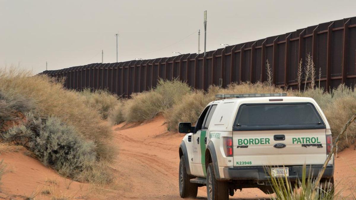A US Border Patrol agent drives near the US-Mexico border fence in Santa Teresa, NM. Donald Trump promises to build a wall along the 2,000-mile U.S.-Mexican border to prevent illegal migration.