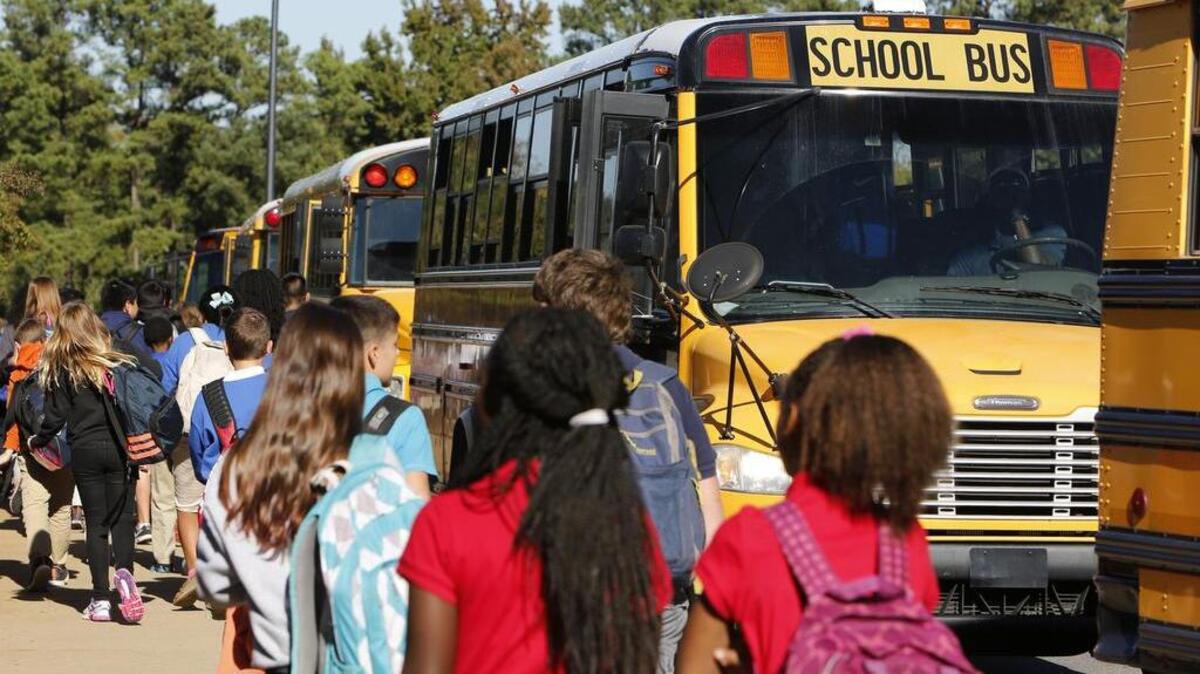 Students head for buses at Sullivan Middle School Wednesday afternoon.