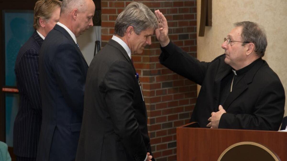 Bishop Robert Guglielmone blesses the newly installed leaders of Providence Hospitals.