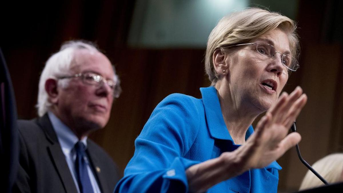 Sen. Elizabeth Warren, D-Mass., right, accompanied by Sen. Bernie Sanders, I-Vt., left, speaks during a news conference on Capitol Hill in Washington, Wednesday, Sept. 13, 2017, to unveil their Medicare for All legislation to reform health care. (AP Photo/Andrew Harnik)