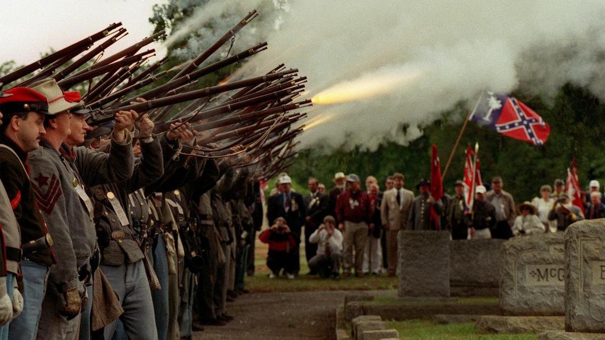 Members of the Palmetto Battalion fire their guns during a Confederate Memorial Day observance at Columbia’s Elmwood Cemetary.