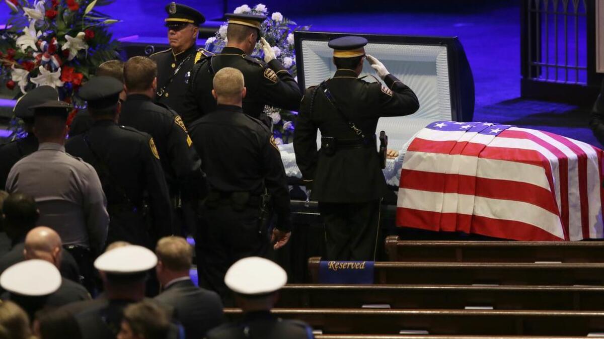 Law enforcement officers salute slain Dallas Police Sr. Cpl. Lorne Ahrens before his funeral in July.