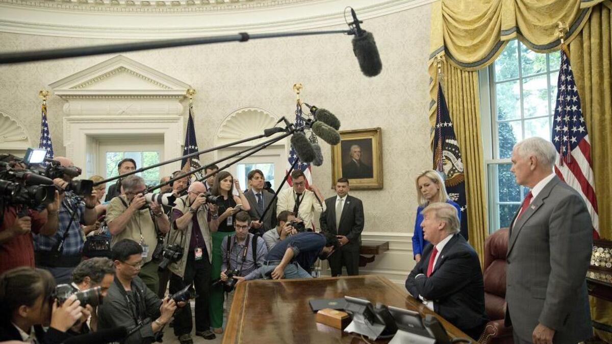 President Donald Trump speaks to members of the news media in June.