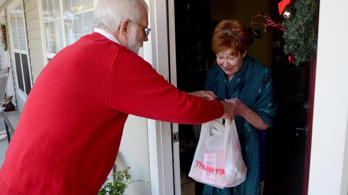 A volunteer makes a Meals on Wheels delivery on Christmas Eve.
