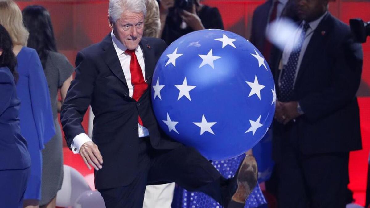 Former President Bill Clinton kicks a balloon at the conclusion of the Democratic National Convention.
