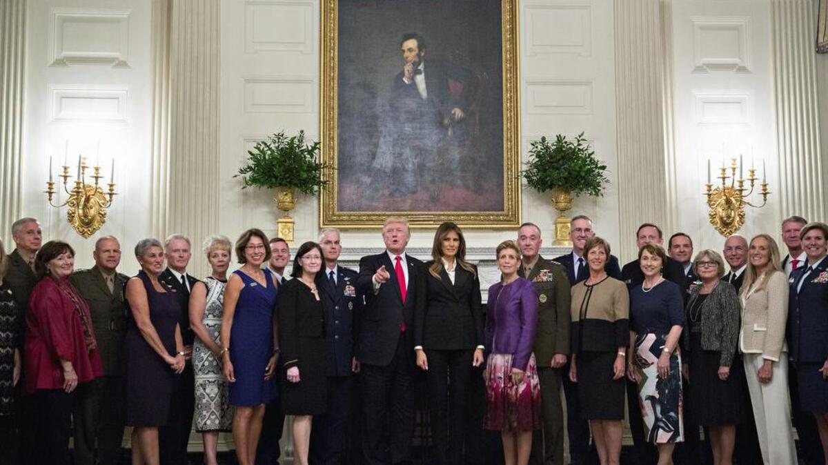 President Donald Trump and first lady Melania Trump pose for photographs with military leaders and their spouses in October.