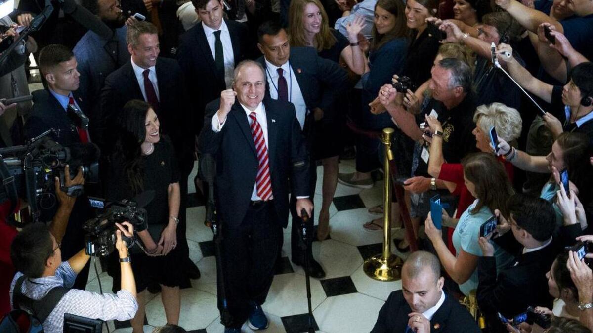 House Republican Whip Steve Scalise walks with his wife Jennifer, left, as he leaves the House chamber on Sept 28.