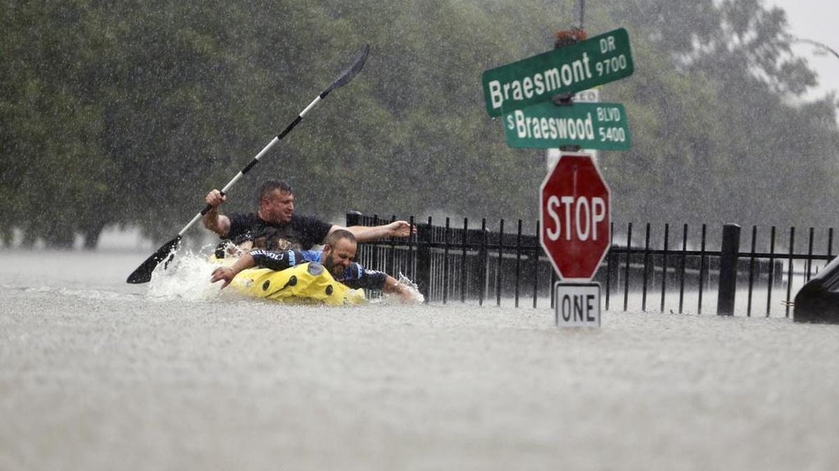 Two kayakers try to beat the current pushing them down an overflowing Brays Bayou from Tropical Storm Harvey in Houston last month.