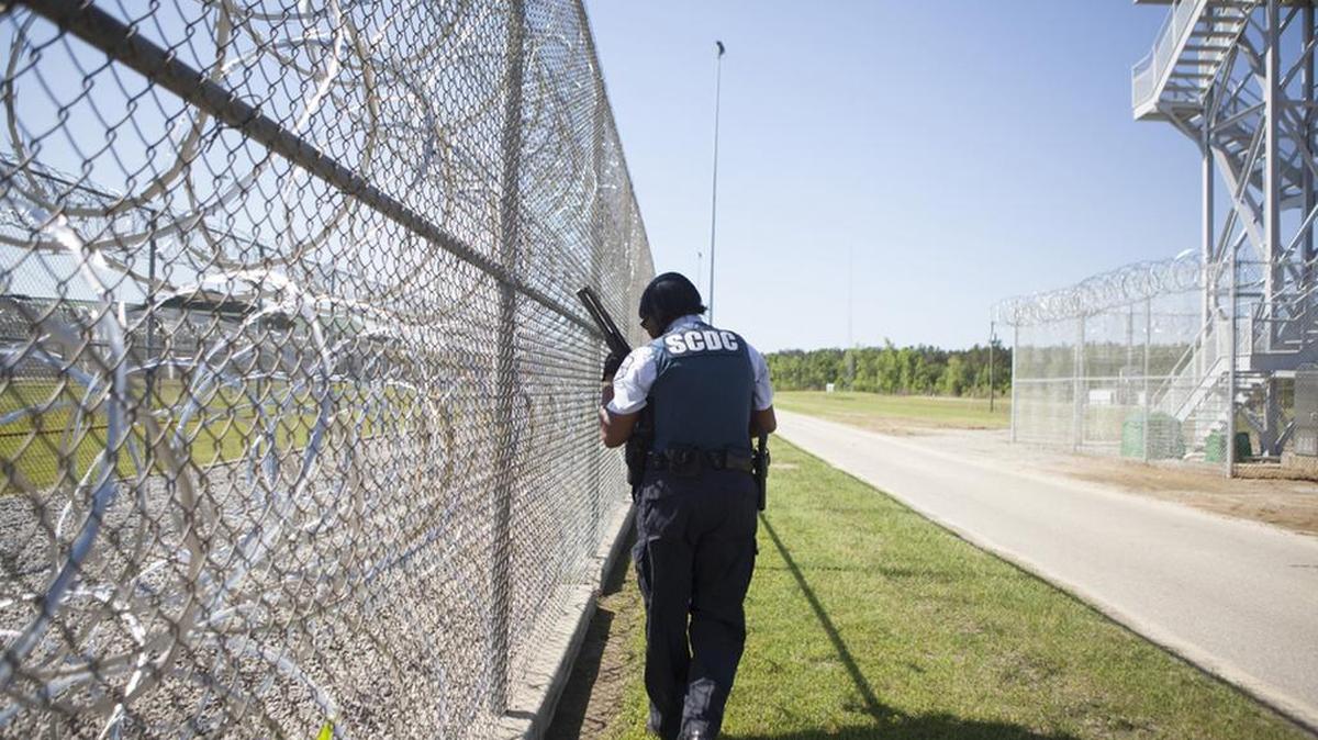 A SC Department of Corrections officer patrols outside of Lee Correctional Institution in Bishopville.