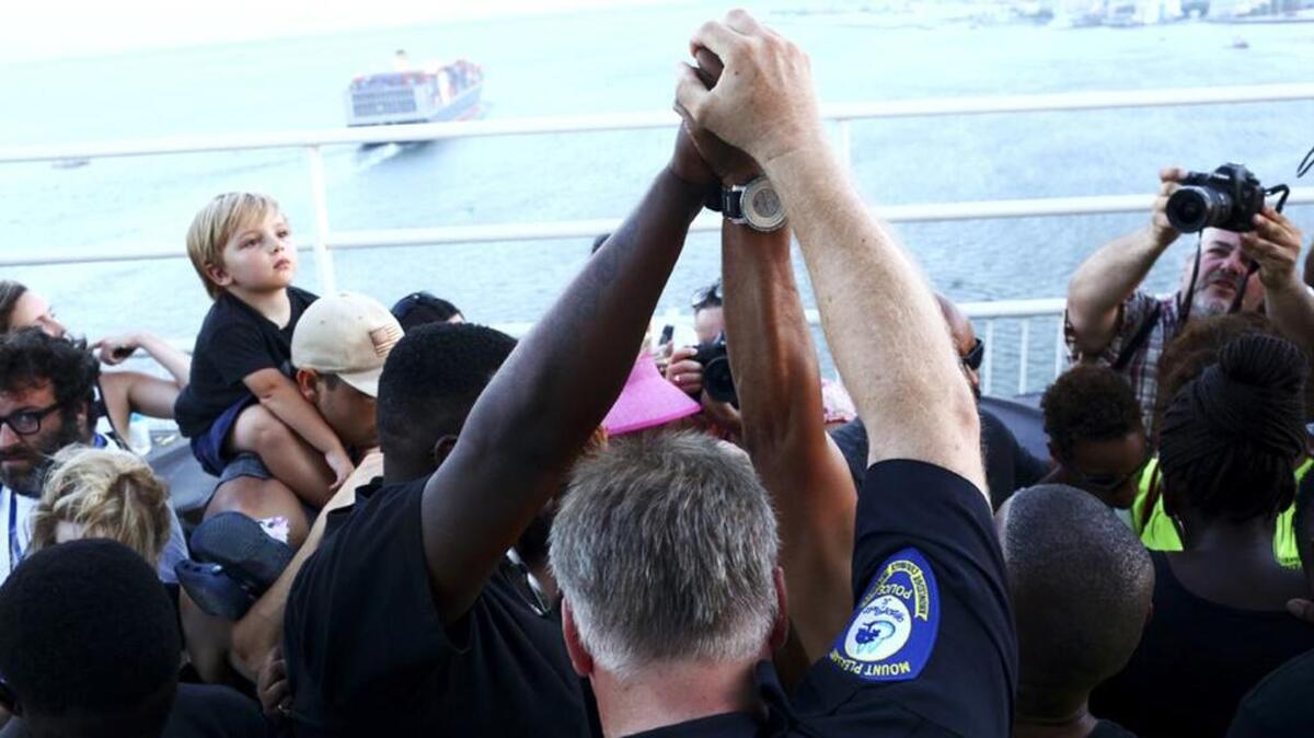 Participants in a unity chain event hold hands on the Arthur Ravenel Jr. Bridge in Charleston after nine churchgoers at Emanuel AME Church were killed in a racist attack.