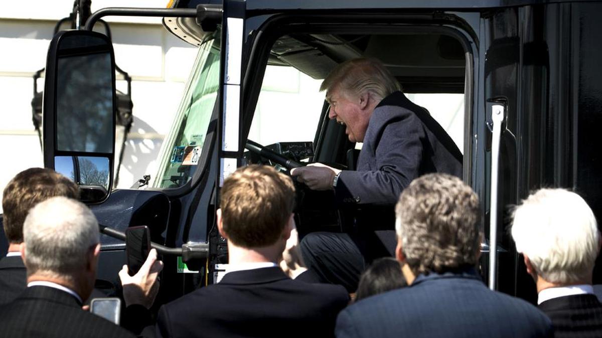 President Donald Trump jokes like he’s driving a semi-trailer truck as he welcomes truckers and chief executives to the White House.