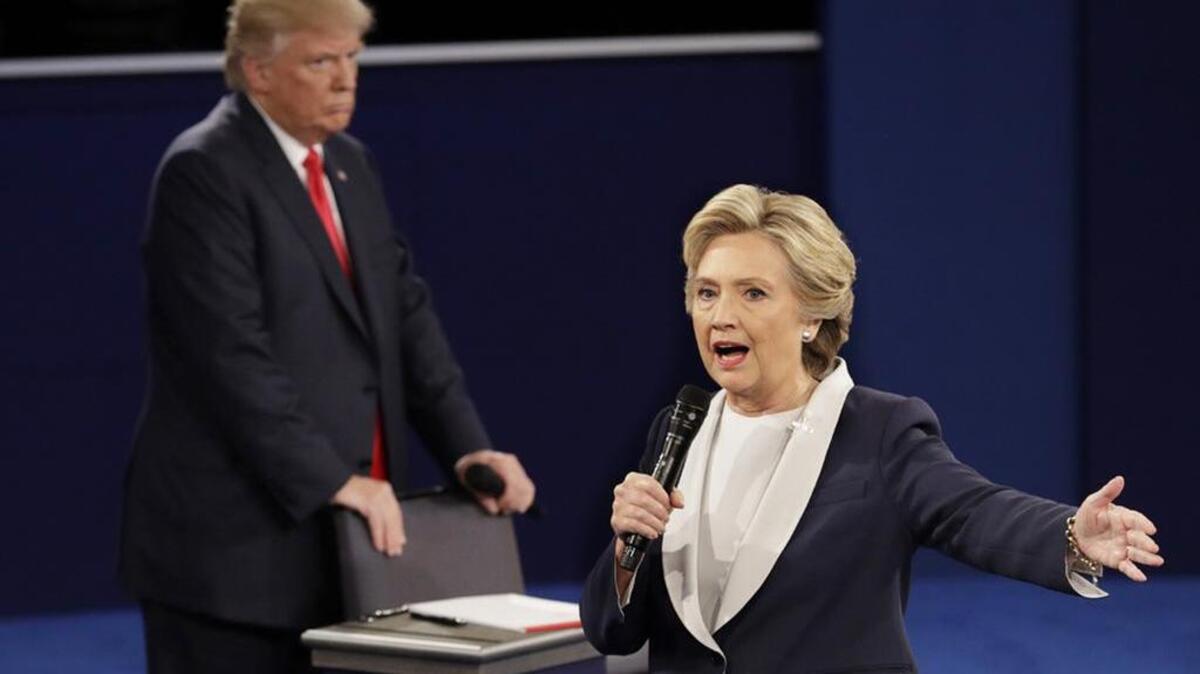 Republican presidential nominee Donald Trump listens to Democratic presidential nominee Hillary Clinton during their second debate on Sunday.
