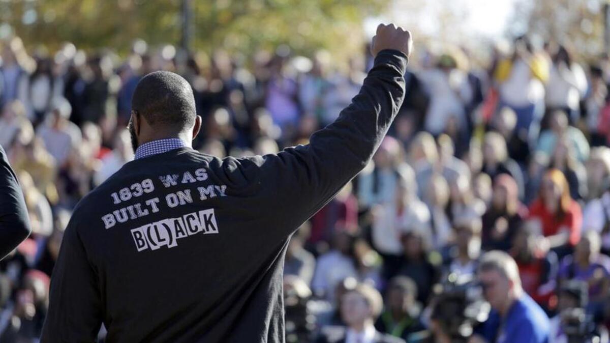 A member of the black student protest group Concerned Student 1950 addresses a crowd following the announcement that University of Missouri System President Tim Wolfe would resign, at the university in Columbia, Mo.