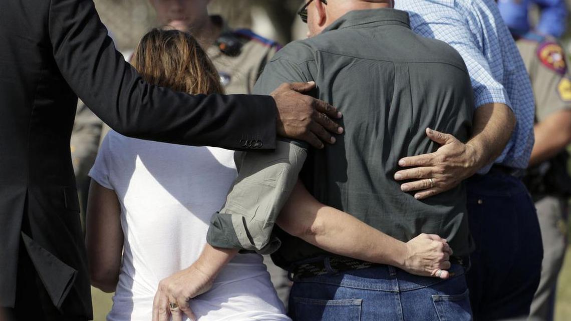 Pastor Frank Pomeroy and his wife, Sherri, are led away from a news conference Monday near the First Baptist Church of Sutherland Springs, Texas.