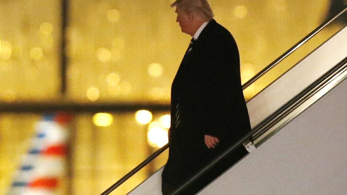 President-elect Donald Trump walks down the stairs from his plane on Tuesday.