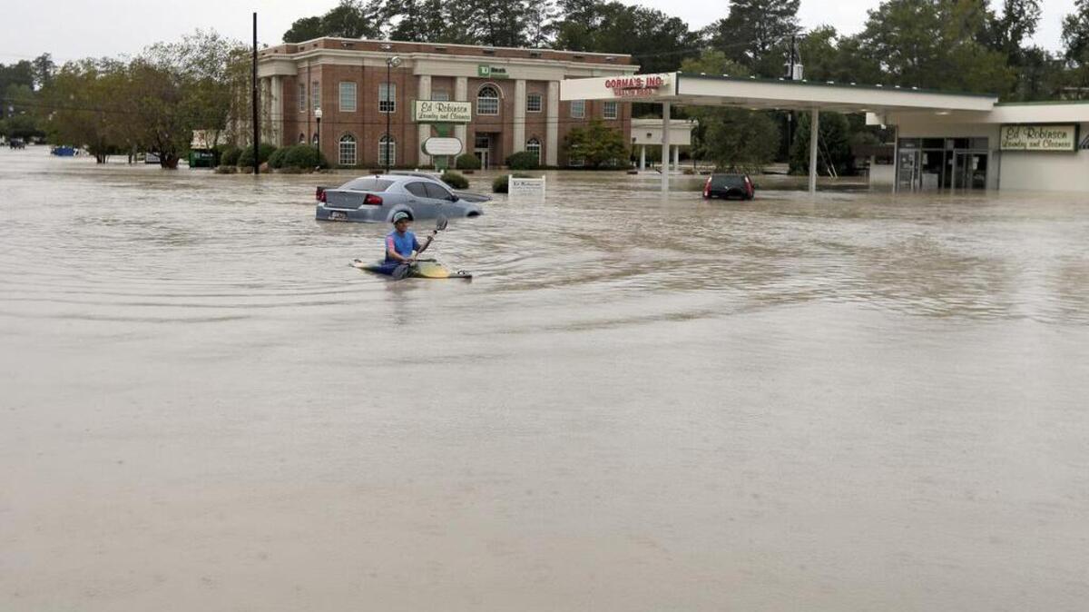 Homes, businesses and entire sections of town were left underwater after dams failed in the October deluge.