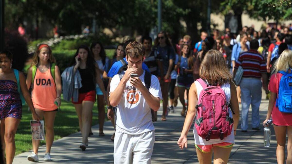 University of South Carolina students make their way past the Russell House on campus.
