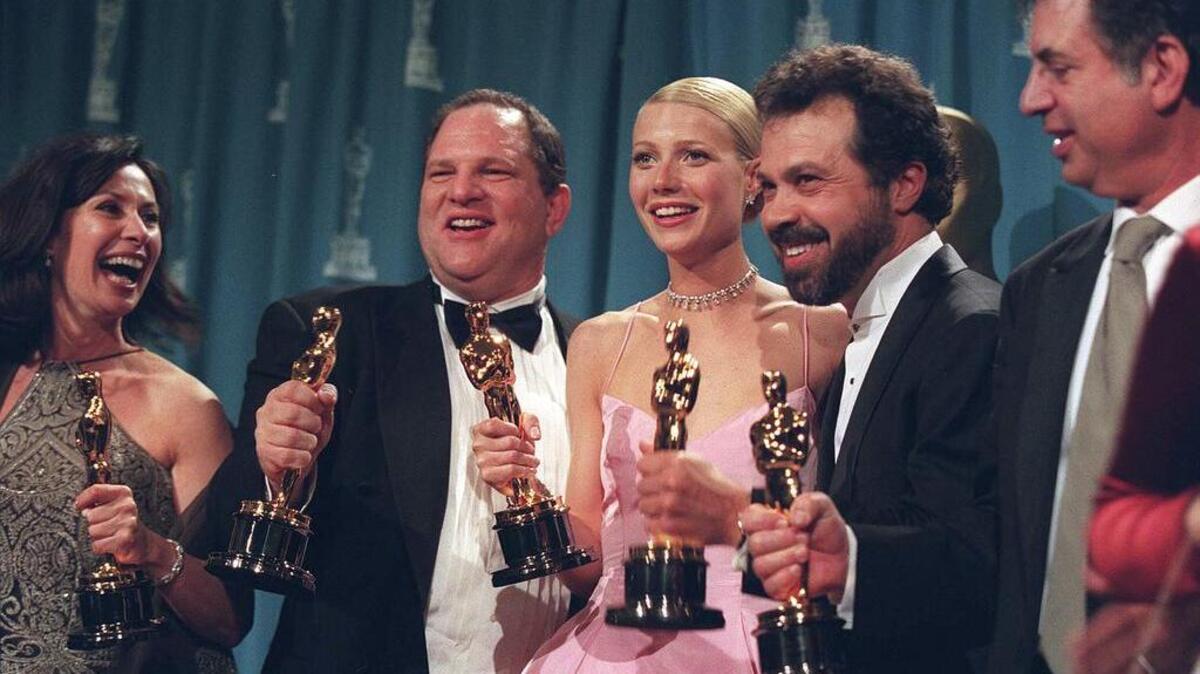 Producer Harvey Weinstein, second from left, celebrates alongside the actress Gwynneth Paltrow and other producers of “Shakespeare in Love” after their film won the best picture Oscar in 1999. Paltrow and other actresses have come out to accuse Weinstein of casting-couch abuses.