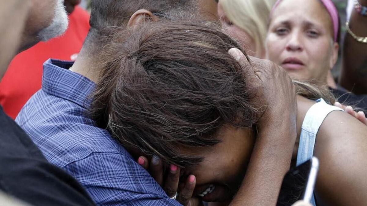 Diamond Reynolds, the girlfriend of Philando Castile, is consoled by a minister outside the governor’s residence in St. Paul, Minn., on Thursday. Castile was shot and killed after a traffic stop by police in Falcon Heights Wednesday night. A video shot by Reynolds of the shooting went viral. (AP Photo/Jim Mone)
