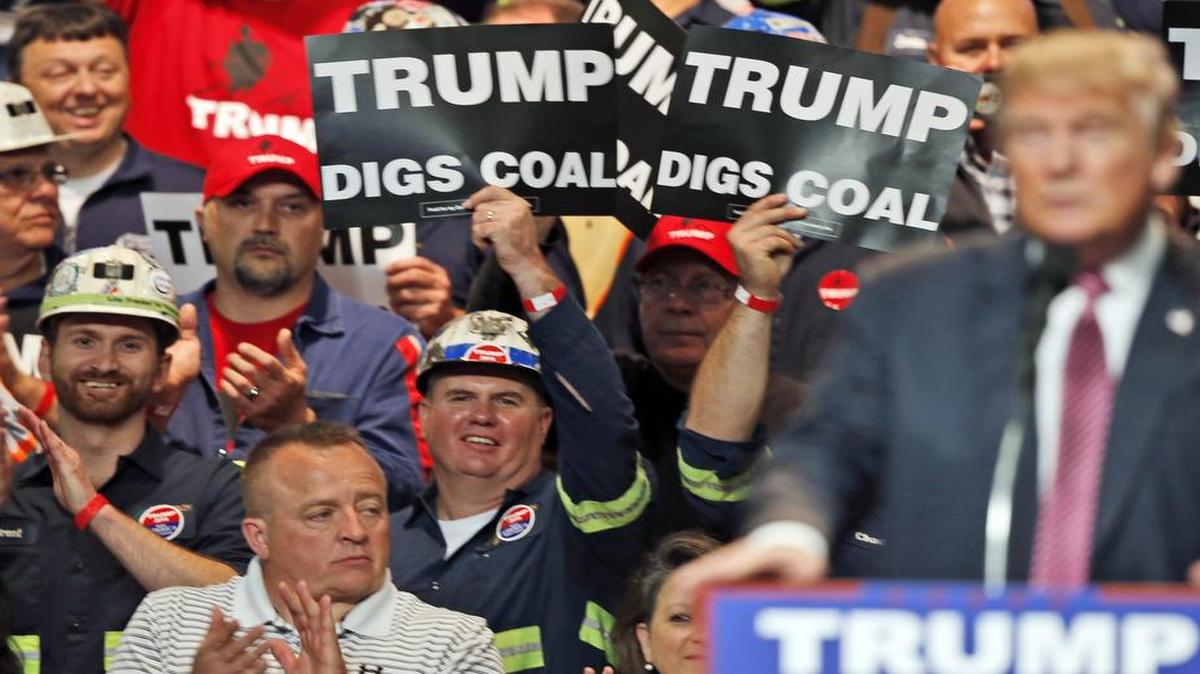 Coal miners wave signs as then-candidate Donald Trump speaks during a 2016 campaign rally in Charleston, West Virginia. In May, President Trump ordered the repeal of the Clean Power Plan that promoted, among other things, nuclear energy.