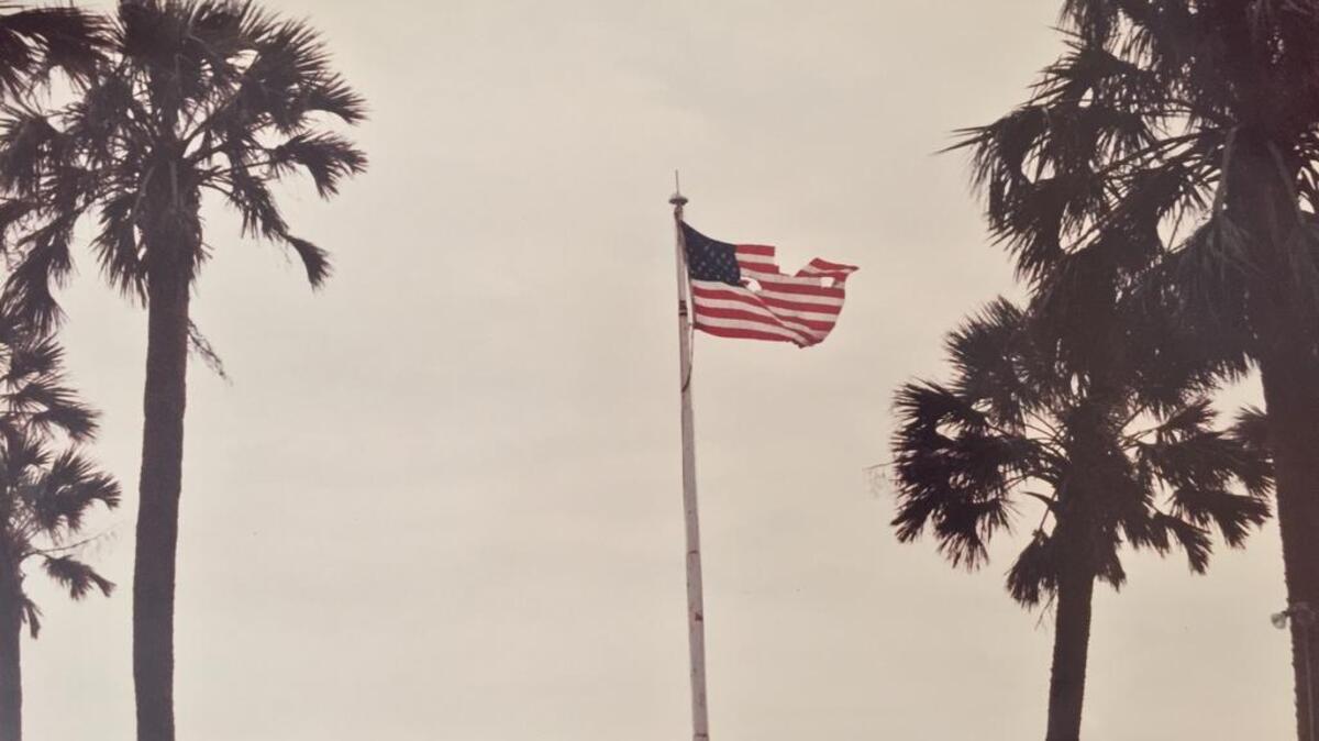
“Invincible” tattered flag photo copyrighted by Katherine J. Trimnal, taken at Sullivan’s Island, SC, on Sept. 24, 1989. Mrs. Trimnal is a photojournalist and lifelong resident of Columbia, SC.
